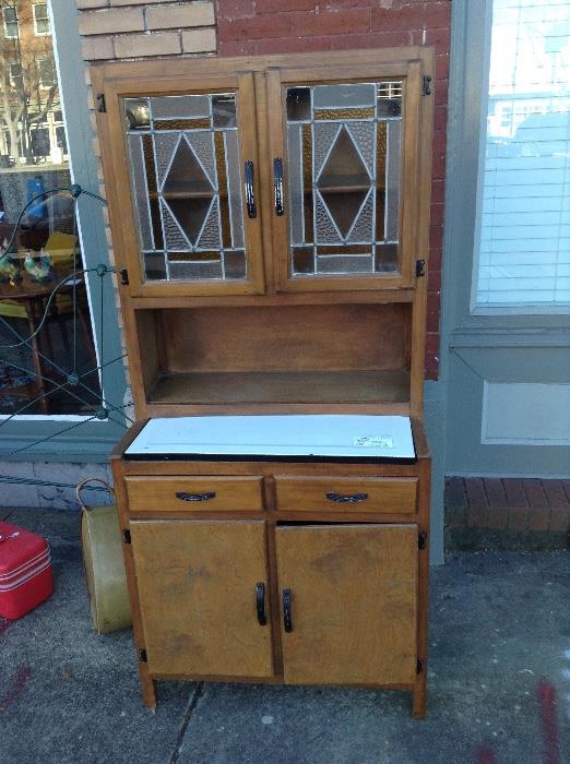 Great Hoosier cabinet with enamel counter and staned glass.