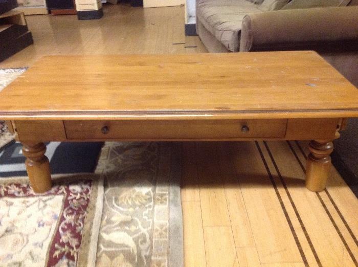 Solid coffee table with one large drawer -$50