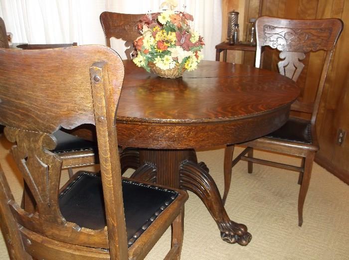 Antique round oak claw foot table & four chairs