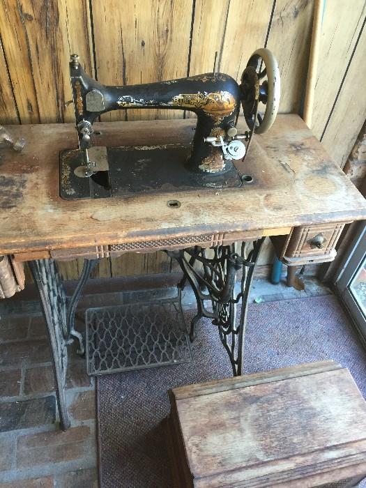 old time Singer treadle sewing machine with case top