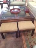 Four stools nest under this coffee table.