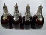 ANTIQUE TANTALUS WITH 4 AMBER GLASS DECANTERS WITH SILVER STOPPERS AND PLAQUES