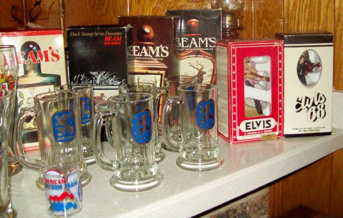 Jim Beam decanters and vintage Lowenbrau mugs.