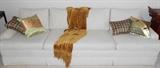 White sofa accented with beautiful pillows (sold separately)