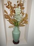 Celadon colored vase with floral arrangement