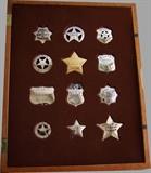 ~  Dated 1987 cased collection of 12 Sterling Old West replica badges