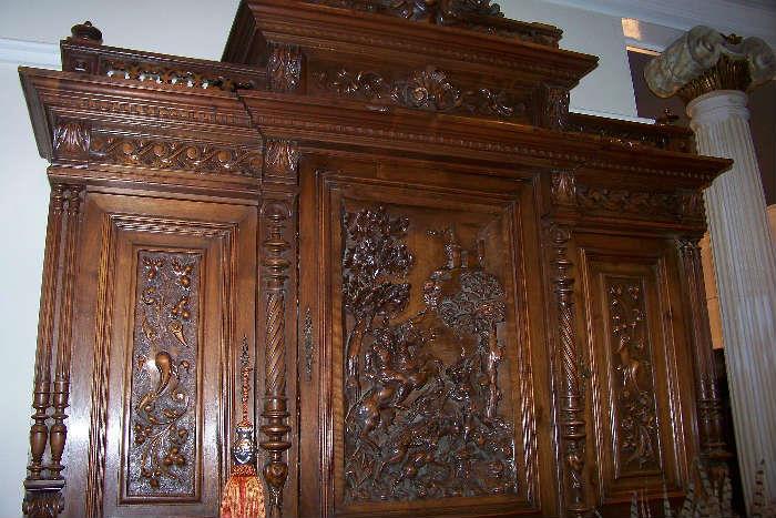 Top of the beautiful English oak cupboard in the large den.  The carving is stunning - the piece has a beautiful patina.  