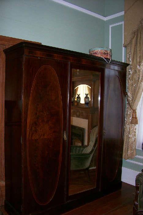 English mahogany armoire - beautiful burled wood on each of the doors with a center mirror.  