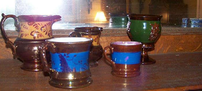 Just a few of the English and American copper lustre pitchers and cups