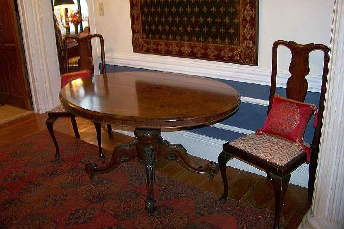 Gorgeous burled center table with a magnificant base.  The table is highlighted on the top with inlay.  ALso shown are a pair of 1930's Queen Anne chairs