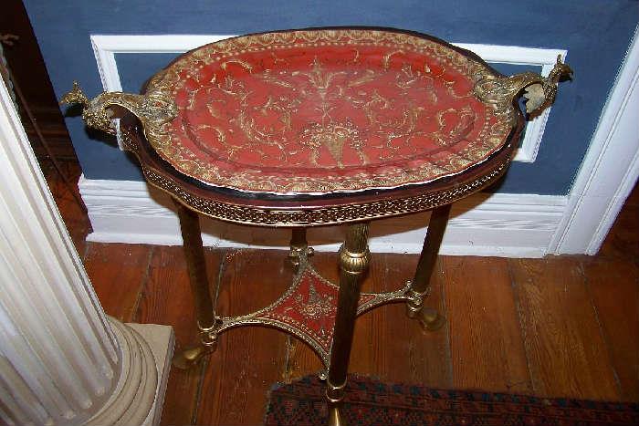 Great looking tray table.  It features a porcelain lift off tray with gilt brass handles and trim.