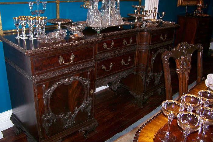 The sideboard is mahogany with flame mahogany on the drawer and door fronts. It is Irish, dating to 1870-1880 and features a beautiful brass gallery