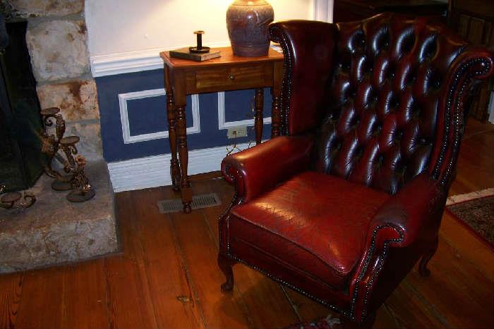 One of a pair of red leather wing chairs