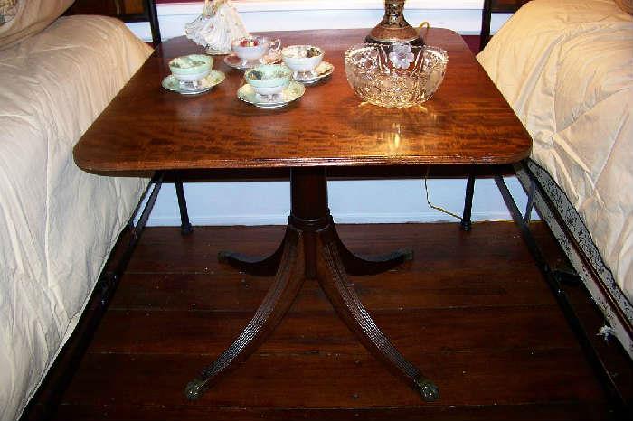 Beautiful mahogany tilt table with brass casters