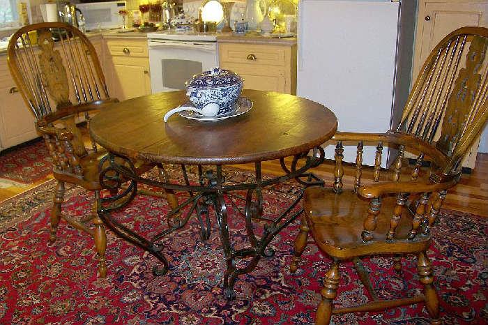 Kitchen table - heavy iron base with a wooden top.  The chairs are of oak