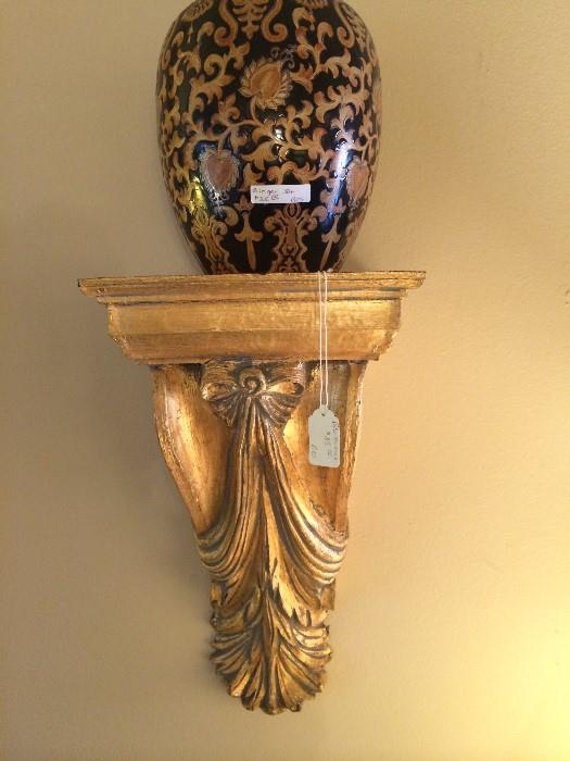               One of two gold sconces
