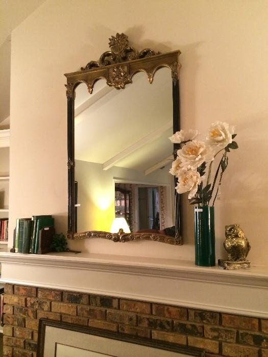          One of several gold framed mirrors