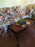             Coffee table, gold oval tray, & floral sofa