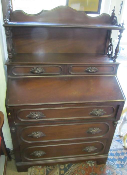 Mahogany slant front desk 2 over 3 drawers with gallery. Pull out supports for desk front when lower/open. Carved handles. 54 1/2" High X 34" Wide X 19" Deep