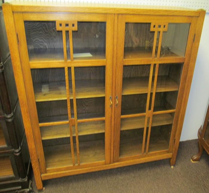 #28 Arts & Crafts Oak  2 door bookcase with 6 1/2 shelves on casters 53 1/2" High X 47" Wide X 13 1/2" Deep