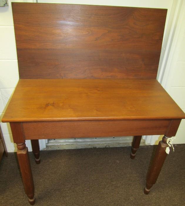 Walnut Game Table. Leaf will lay flat and rotate 90 degrees so as to form larger surface. Closed with leaf laying down it measures 29 1/2" High X 35" Wide X 17 1/2" Deep - with leaf down and turned it becomes 35" square. Storage area under leaf