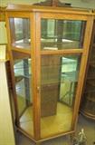 Oak flat front & sides 3 glass shelves partially mirrored back on casters 64 1/2" High X 67" High to top of splash board X 36" Wide X 14" Deep