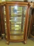 #6 Oak Empire bow front china cabinet on casters 4 glass shelves w/interior light 66" High X 46 1/2" Wide X 19" Deep