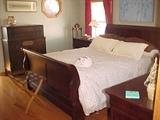 nice newer bed, with matching armoire, dresser, and 2 night stands
