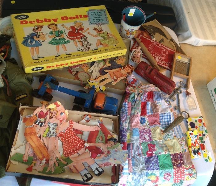 Old tin pail with shovel, old quilted skirt, asst vintage paper dolls, old metal toy trucks and more!