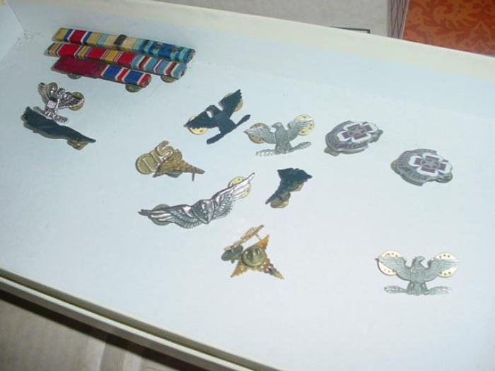 Some of the military medals, plus uniforms of navy, Air Force, and Army