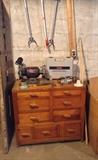Cool hand made storage chest with diamond-shaped drawer pulls, Craftsman 1/3 hp/6 inch bench grinder with light, Ryobi cordless drill driver (Model TFD-170VR)