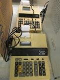 Two Canon electric adding machines, with paper printout.