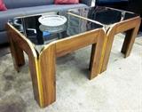 Two 24" square end tables. Black glass tops with wood bases and goldtone trim. Can be used together as a coffee table or seperately as end tables.