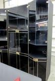 Black 3-section wall unit with glass doors and goldtone trim. Area for TV and entertainment components, 5 lighted display areas and lots of bottom storage. Overal dimensions 71" w x 78" h.