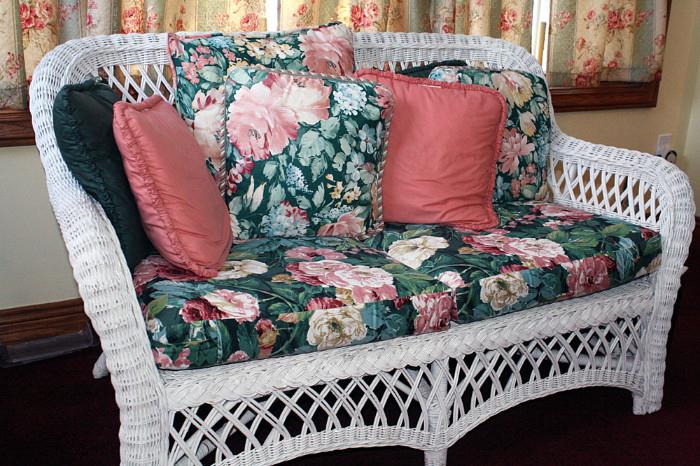 White Wicker love seat includes cushions and pillows