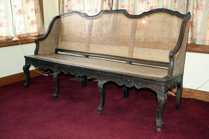 Louis 14th or 15th style settee. Possibly walnut. Damage to cane on left seat