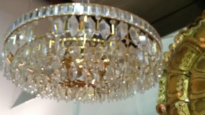 Not a great pic, but this is an English MCM crystal chandelier, that looks as if it's gold plated. Squint.