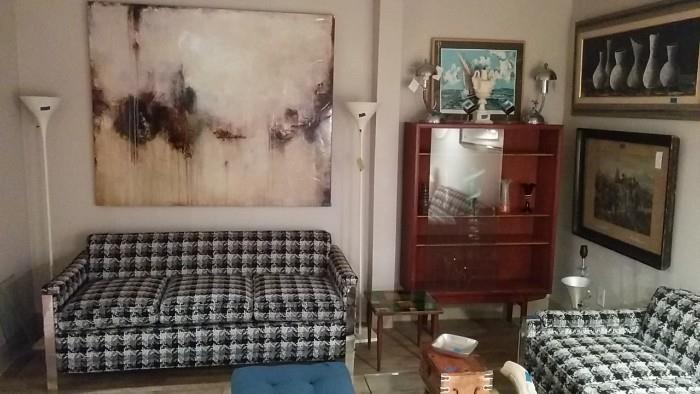 Impressive size, but not great wall art, pair of houndstooth sofas, pair of metal torchiere floor lamps, original artwork, Arne Vodder bookcase/display cabinet, pair of 1950's chrome table lamps (golfers).