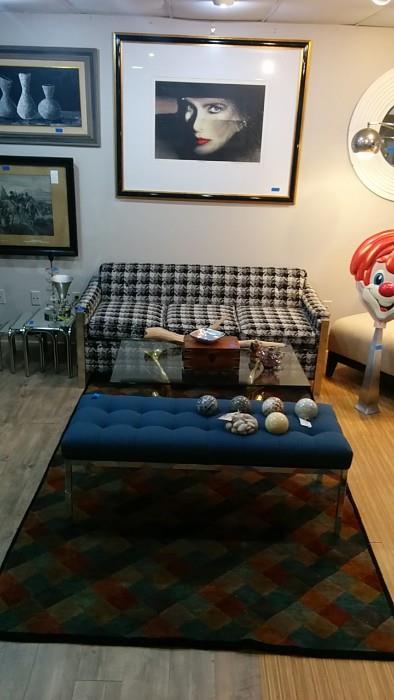 Signed, numbered artwork by Paul Chelko, brass dolphin coffee table, chrome bench, w/blue cushion, 100% wool hand woven rug (8' 10" x 5' 1"). 