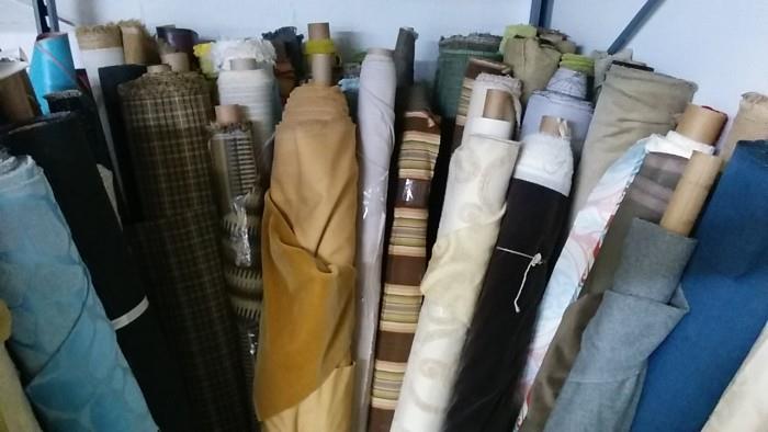 It's endless. There are rolls of linen, vinyl, velvet, mohair - plaids, striped, solids, leather, leather hides, etc. Call your favorite upholsterer and tell them to hot-foot it down here!