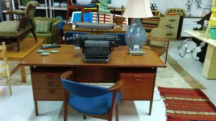 Straight from the set of "Mad Men", this Kai Kristiansen desk, outfitted with vintage Royal typewriter, dual magnetic ink pen set, industrial green cigarette case, w/3 ashtrays, Arne Vodder swivel-back armchair and pack of Vantage playing cards, from the Stardust hotel, Las Vegas, the voluptuous secretary is ready to take dictation!                                                                 Voluptuous secretary not included in this "Love for Sale" sale. 