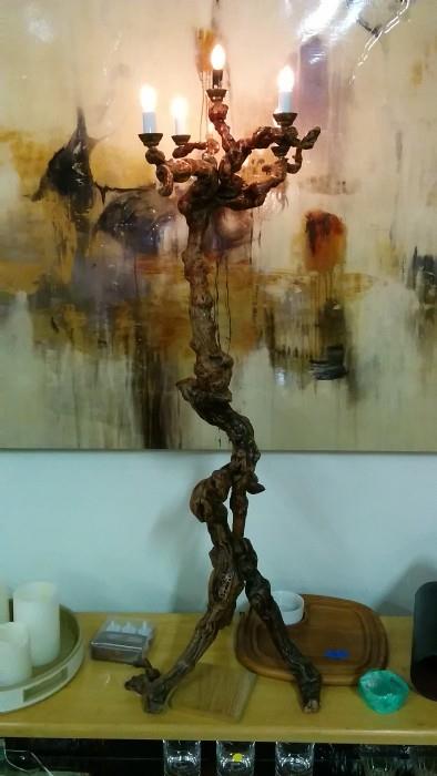 A contorted, wooden 5-light floor lamp. Very cool indeed! Don't let the mass-produced wall art behind it fool you.