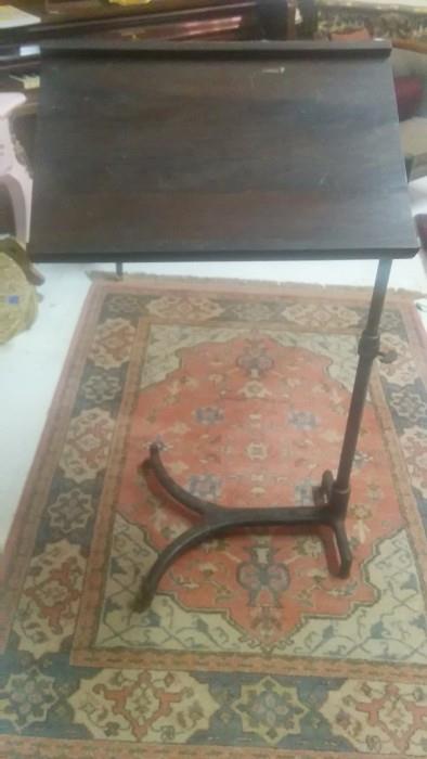 Antique swiveling book/music stand, manufactured by Shampaine Aseptic Style Furniture Co., St. Louis, MO, for all those contortionist musicians in our lives.    Actor, waiter, model, contortionist, whatever pays the bills.