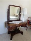Beautiful Regency style vanity with carved stand and floating mirror.