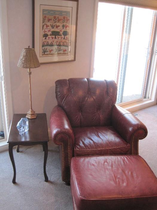 Leather armchair with matching footstool. 
