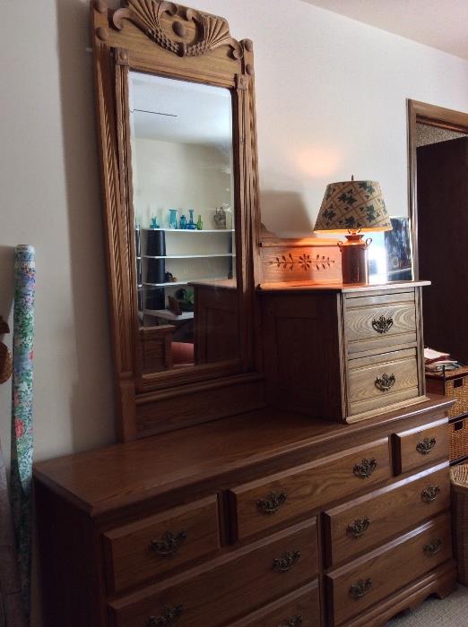 oak chest of drawers.  on top there is an antique mirror with small 2 drawer chest attached to the mirror.  That unit is not attached to bottom piece.