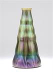 1015  A Loetz iridescent art glass vase
Early 20th century, signed ''Loetz / Austria'', of undulating tapering form rising to a slightly flared mouth, with striations of iridescent purple and green on a spring green ground, 13.75'' H x 7'' Dia., est: $400/600

Provenance: Private Collection, Tujunga, CA.  Condition: Overall good condition. General light marks, scratches, and rubbed wear commensurate with age and handling. Three light spots of darker discoloration localized to center body; the largest approximately .25'' x .25''. Scattered white-colored scuffs around base; the largest approximately .125'' x .25''.    Your bid indicates acceptance of our Conditions of Sale.  AS-IS.  ALL SALES FINAL