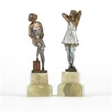 1024  Two Vienna cold-painted bronze figures, Bruno Zach (1891 - 1945 Austrian / German)
Early 20th century, each signed to base ''Zach'' and stamped ''Made in Austria'', each depicting a scantily clad female figure; one posing, the other adjusting her stockings, each raised on a stepped square green onyx base, 2 pieces, the first: 5.75'' H x 1.5'' W x 1.5'' D; the second: 5.5'' H x 1.625'' W x 1.625'' D, est: $1000/2000

Provenance: Private Collection, Encino, CA.  Condition: Overall good condition. General minor scratches, marks and rubbed wear commensurate with age. Chips and scattered fleabites to bases.  Your bid indicates acceptance of our Conditions of Sale.  AS-IS.  ALL SALES FINAL