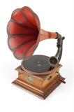 1041  A Pathe disk phonograph with horn
Early 20th century, French, marked to stylus arm ''Reproducteur pour disques / Pathe / Brevte SGDG / Pathe Multitone'', further marked to case ''Les Disques Pathe Chantent Sans Aiguille'' (Pathe disks sing without needle), adjustable-speed manual-wind, fitted with a red bell-shaped horn, accompanied by one 10.5'' Dia disk, 25.5'' H x 15.5'' W x 20'' D, est: $500/700

Provenance: Private Collection, West Hills, CA.  Condition: Winds and runs. Warping to cover of case; does not sit flush with housing. Chip to connecting shaft of stylus arm; does not securely screw into horn terminal. Scattered shrinkage cracks and chips to case primarily localized around lower beveled edge and scuffs and scratches to horn commensurate with age and use.  Your bid indicates acceptance of our Conditions of Sale.  AS-IS.  ALL SALES FINAL