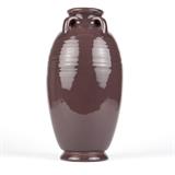 1047  A Rookwood pottery ''Soft Porcelain'' duochrome floor vase
1917, Cincinnati, OH, impressed ''RP'' monogram and flame mark over Roman numeral ''XVII'', further marked with shape number ''2371'', and sideways ''P'' denoting ''Rookwood Soft Porcelain'' body material, of duochrome glaze with turquoise interior and ''Catawba'' purple gloss exterior, the flared mouth over a short, four-handled neck above a baluster-form body, raised on a slightly spreading circular foot, 16.5'' H x 8.5'' Dia., est: $600/900

Condition: Overall good condition.  Your bid indicates acceptance of our Conditions of Sale.  AS-IS.  ALL SALES FINAL